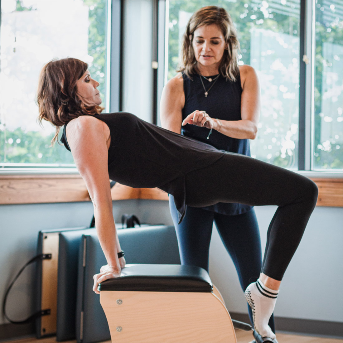 Pilates instructor teaching a private lesson in a classical Pilates studio near Kansas City KS