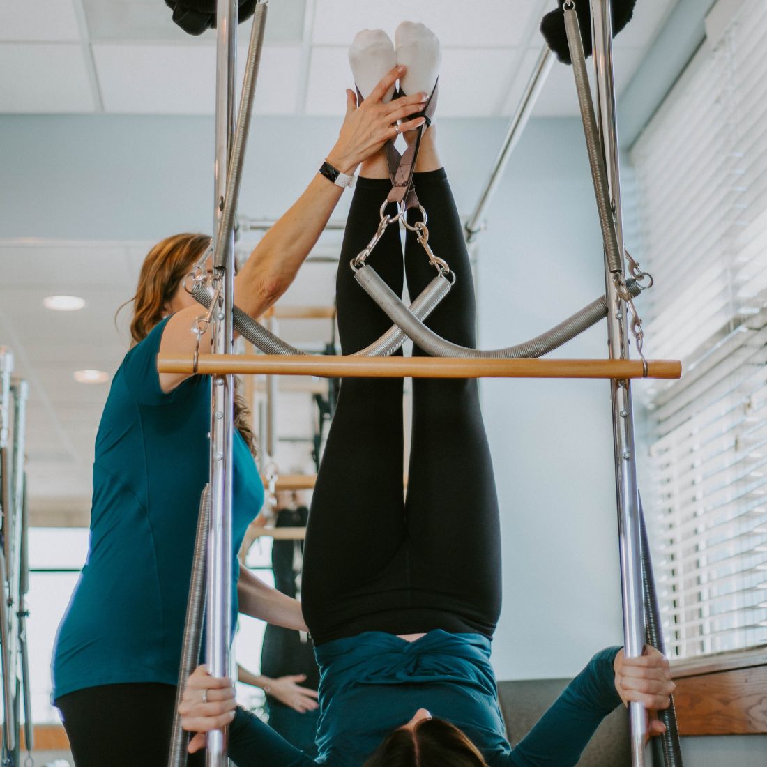 Pilates instructor teaching a client during a private session